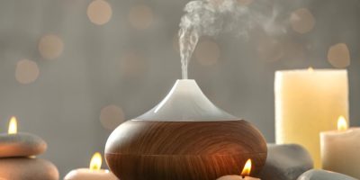essential-oil-aromatherapy-diffuser-surrounded-by-candles